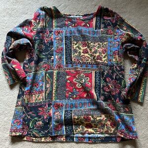 Serengeti knit top. Sequence trim on floral theme.